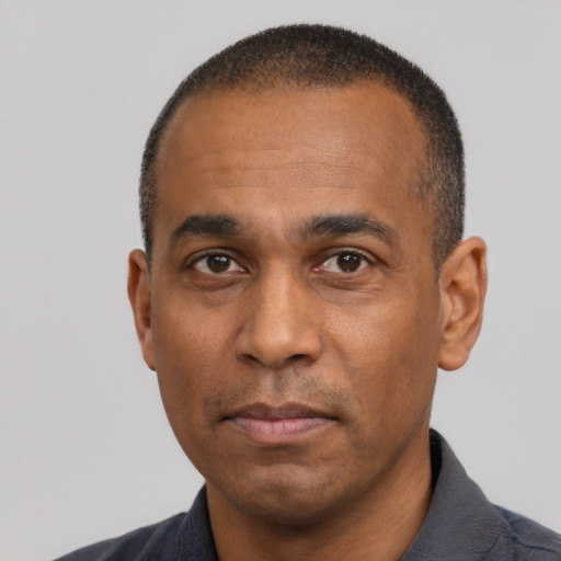 Neutral latino adult male with short  black hair and brown eyes