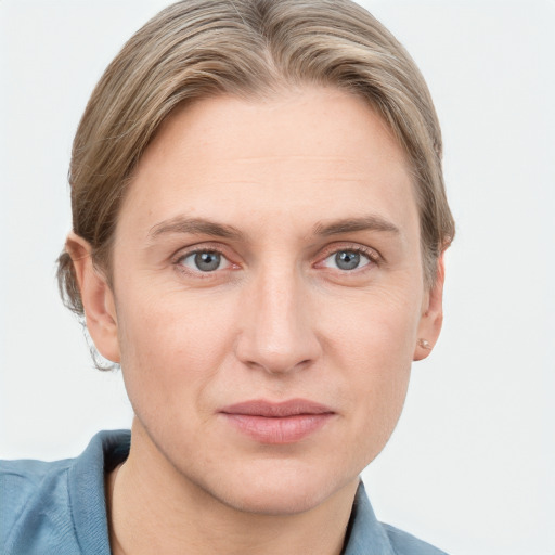 Joyful white young-adult female with short  brown hair and blue eyes