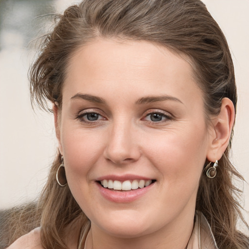 Joyful white young-adult female with long  brown hair and grey eyes