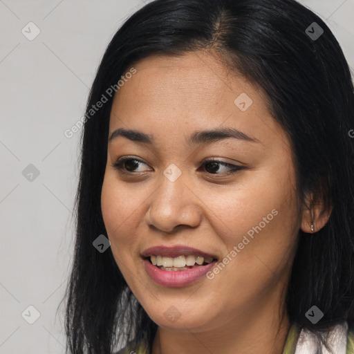 Joyful asian young-adult female with long  brown hair and brown eyes