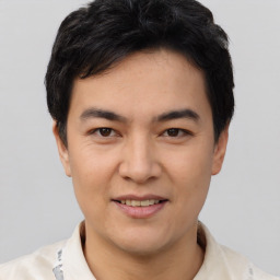 Joyful white young-adult male with short  black hair and brown eyes