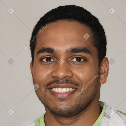 Joyful black young-adult male with short  black hair and brown eyes