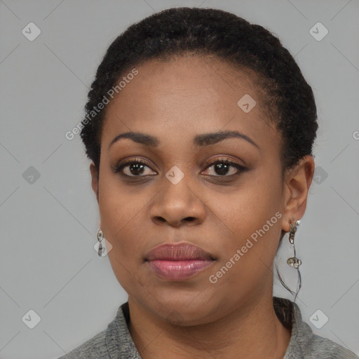 Joyful black young-adult female with short  black hair and brown eyes