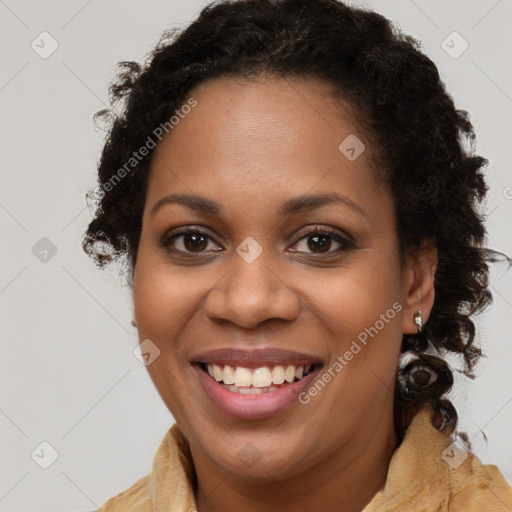 Joyful black young-adult female with long  brown hair and brown eyes