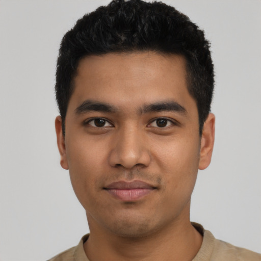 Joyful latino young-adult male with short  black hair and brown eyes