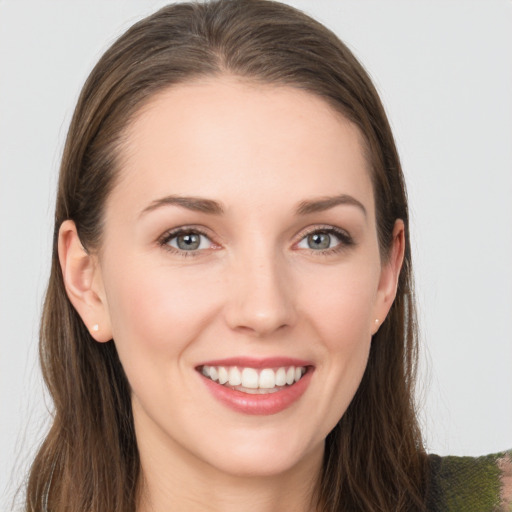 Joyful white young-adult female with long  brown hair and grey eyes