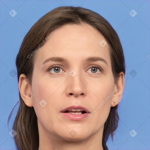 Joyful white young-adult female with medium  brown hair and grey eyes