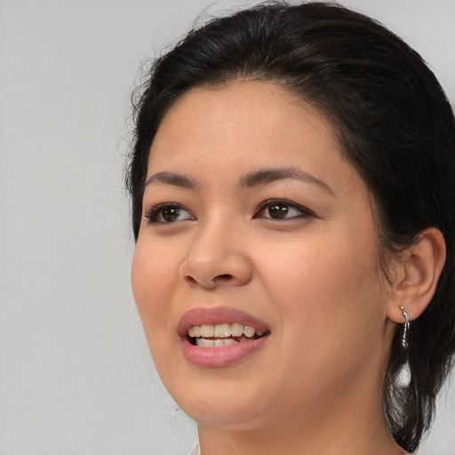 Joyful asian young-adult female with medium  black hair and brown eyes