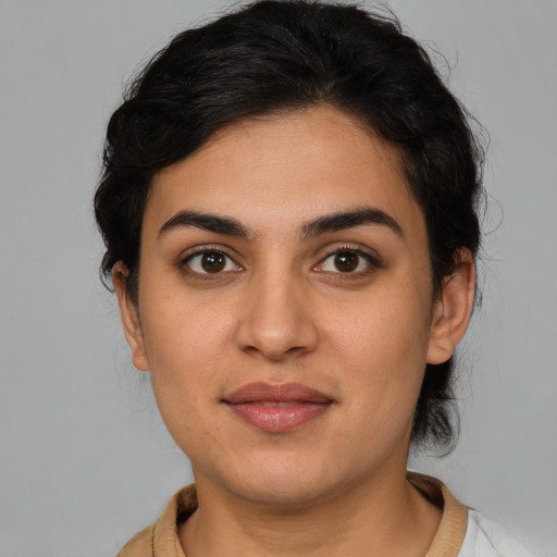 Joyful latino young-adult female with short  brown hair and brown eyes