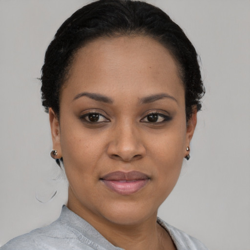 Joyful latino young-adult female with short  black hair and brown eyes