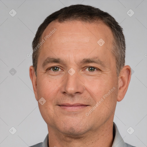 Joyful white adult male with short  brown hair and brown eyes