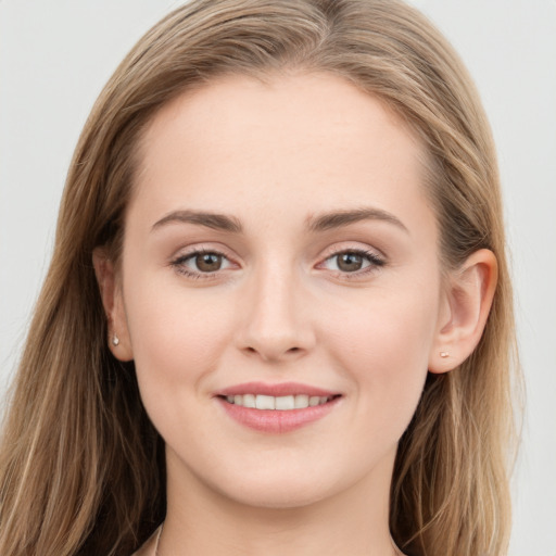 Joyful white young-adult female with long  brown hair and grey eyes