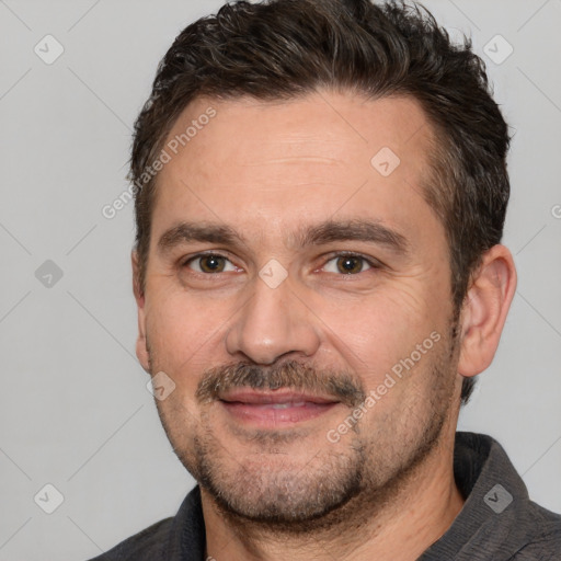 Joyful white adult male with short  brown hair and brown eyes