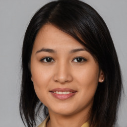 Joyful asian young-adult female with medium  brown hair and brown eyes