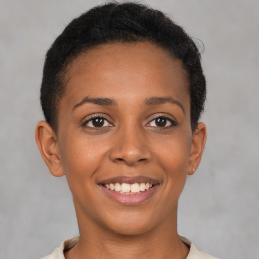 Joyful latino young-adult female with short  brown hair and brown eyes