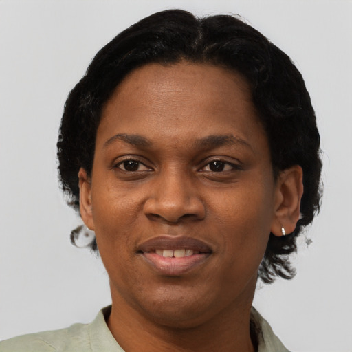 Joyful black adult female with short  black hair and brown eyes