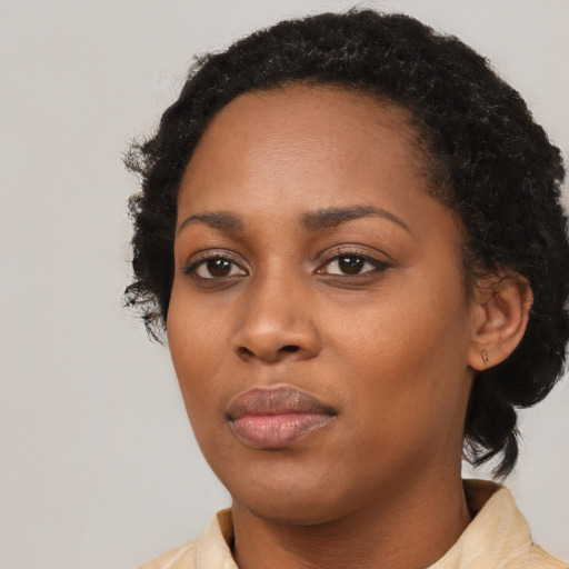 Neutral black young-adult female with medium  black hair and brown eyes