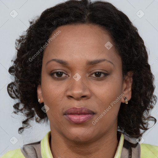 Joyful black adult female with medium  brown hair and brown eyes