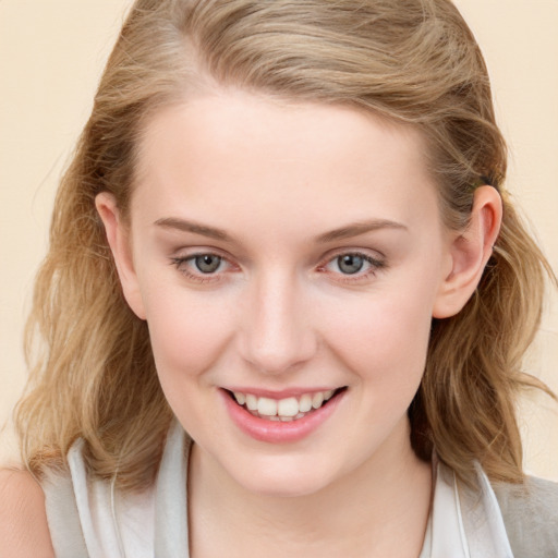 Joyful white child female with medium  brown hair and blue eyes