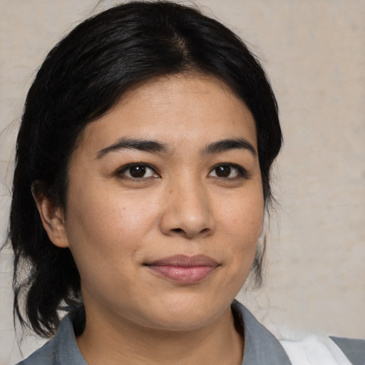 Joyful asian young-adult female with medium  black hair and brown eyes