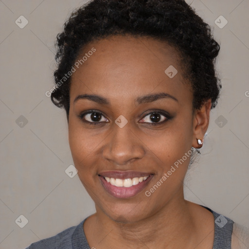 Joyful black young-adult female with short  black hair and brown eyes