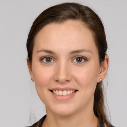 Joyful white young-adult female with medium  brown hair and grey eyes