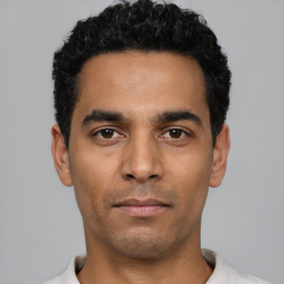 Neutral latino young-adult male with short  black hair and brown eyes