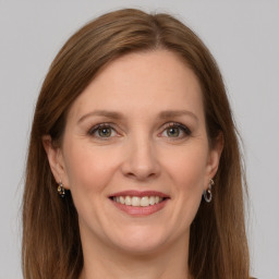 Joyful white adult female with long  brown hair and grey eyes