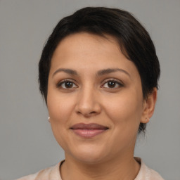 Joyful latino young-adult female with short  brown hair and brown eyes