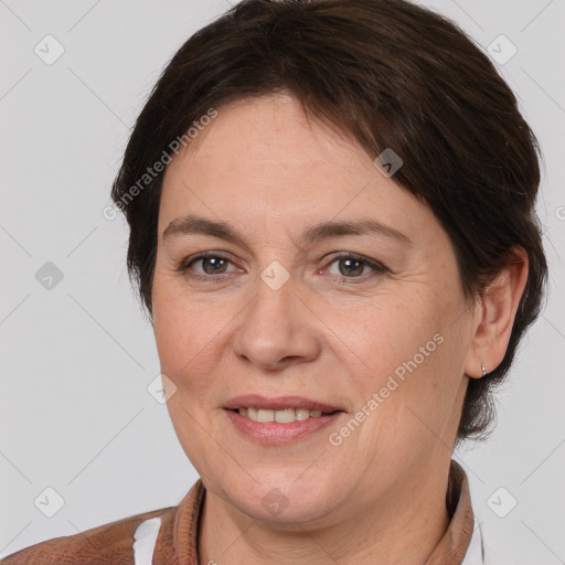 Joyful white adult female with medium  brown hair and brown eyes