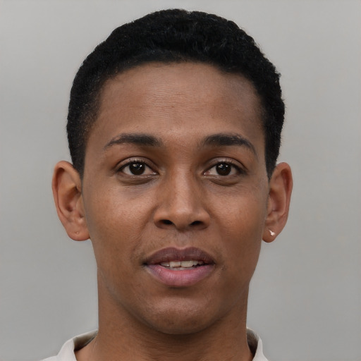 Joyful black young-adult male with short  brown hair and brown eyes