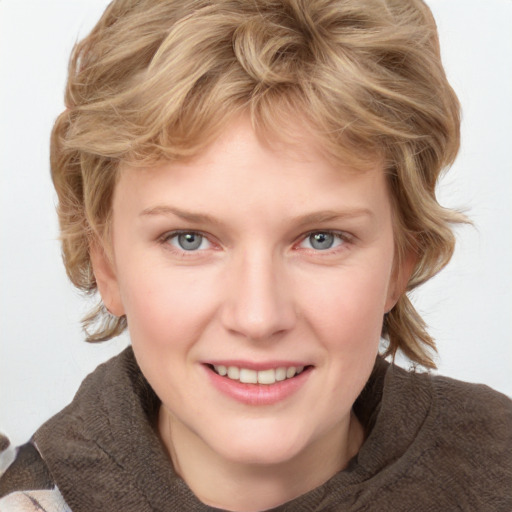 Joyful white young-adult female with medium  brown hair and blue eyes