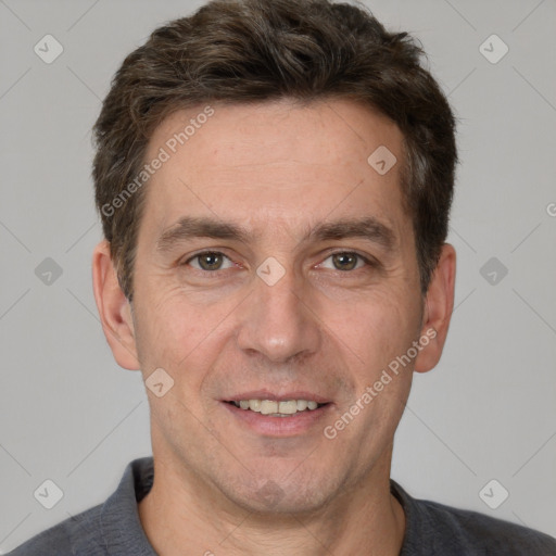 Joyful white adult male with short  brown hair and grey eyes