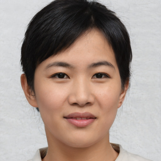 Joyful asian young-adult female with short  brown hair and brown eyes