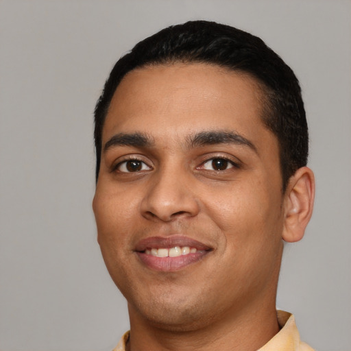 Joyful latino young-adult male with short  black hair and brown eyes