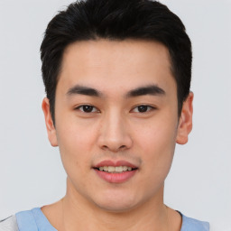 Joyful asian young-adult male with short  black hair and brown eyes