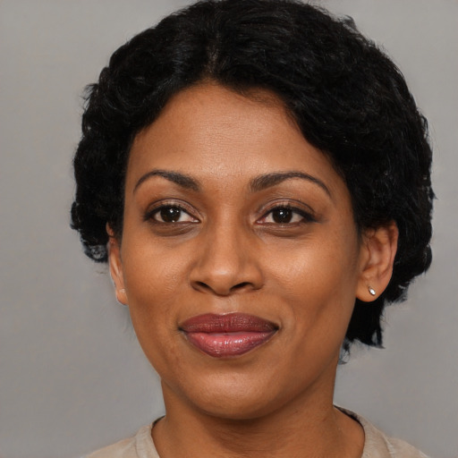 Joyful latino adult female with short  black hair and brown eyes