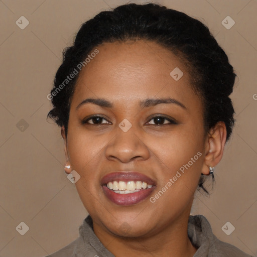 Joyful black young-adult female with short  black hair and brown eyes