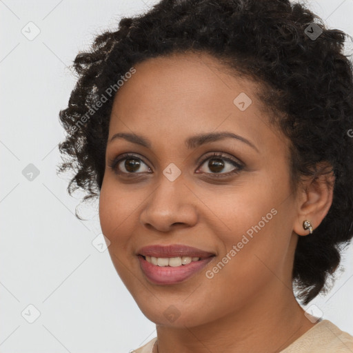 Joyful black young-adult female with short  black hair and brown eyes