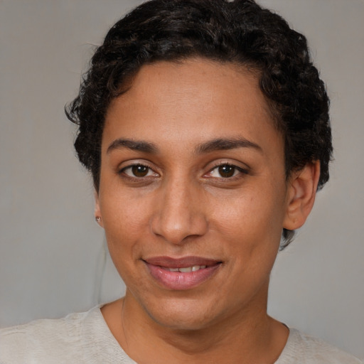 Joyful latino young-adult female with short  brown hair and brown eyes