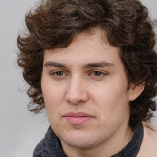 Joyful white young-adult male with medium  brown hair and brown eyes