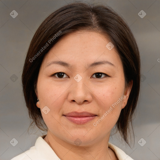 Joyful asian adult female with medium  brown hair and brown eyes