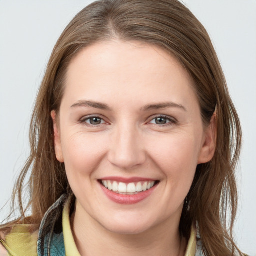 Joyful white young-adult female with long  brown hair and brown eyes