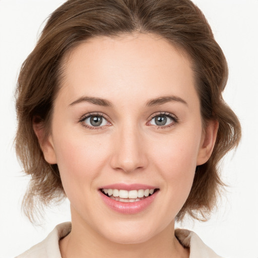 Joyful white young-adult female with medium  brown hair and blue eyes