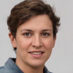 Joyful white young-adult female with short  brown hair and grey eyes