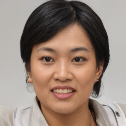 Joyful asian young-adult female with medium  black hair and brown eyes