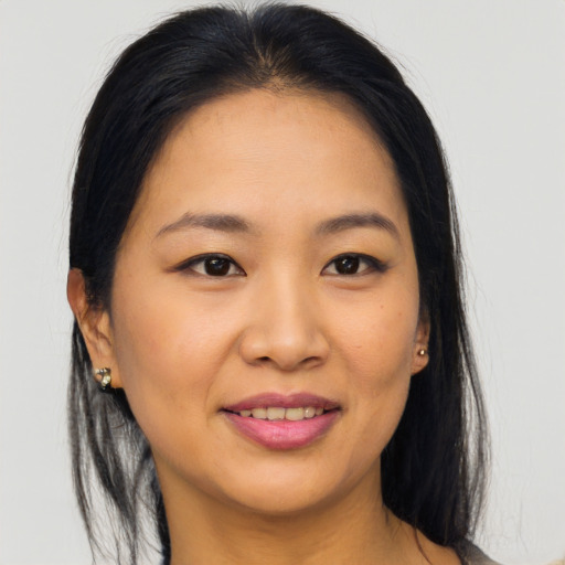 Joyful asian young-adult female with long  brown hair and brown eyes