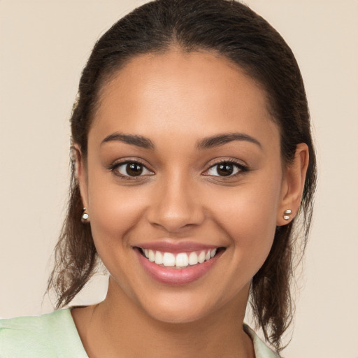 Joyful white young-adult female with long  brown hair and brown eyes