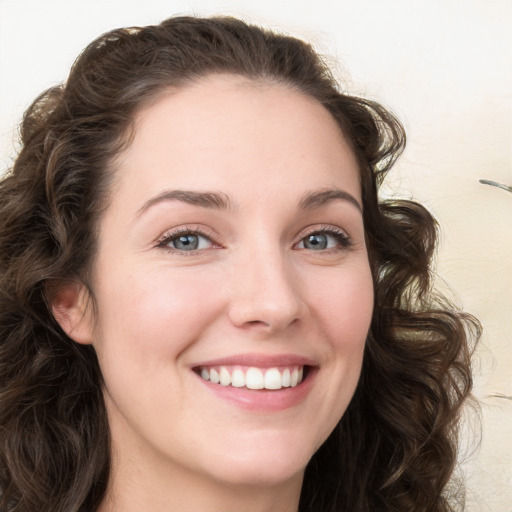 Joyful white young-adult female with long  brown hair and green eyes