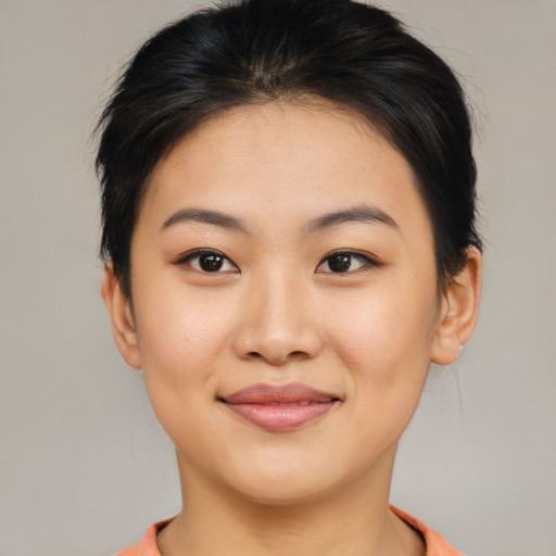 Joyful asian young-adult female with short  brown hair and brown eyes